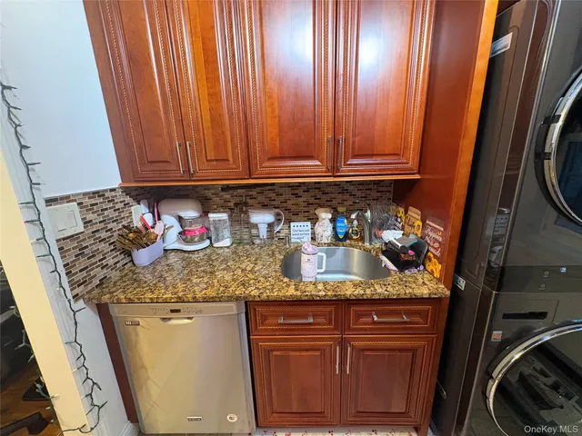 a kitchen with stainless steel appliances granite countertop a refrigerator a stove and a sink