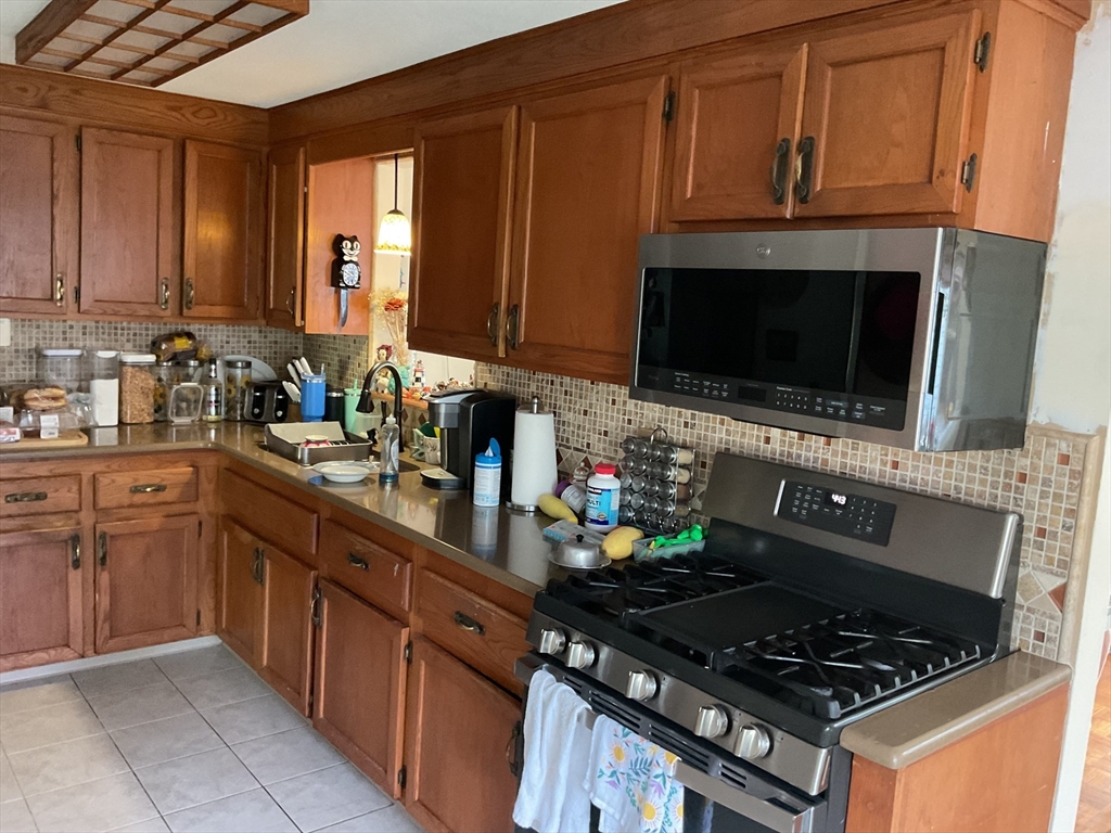 41 Hillside Drive Springfield, MA 01118 - Photo 3 of 25 a kitchen with stainless steel appliances a stove a sink dishwasher and a microwave