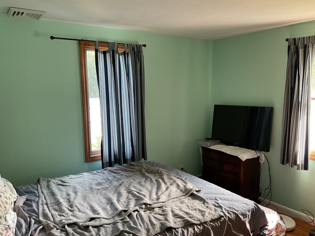 41 Hillside Drive Springfield, MA 01118 - Photo 8 of 25 a bedroom with a bed and a flat tv screen