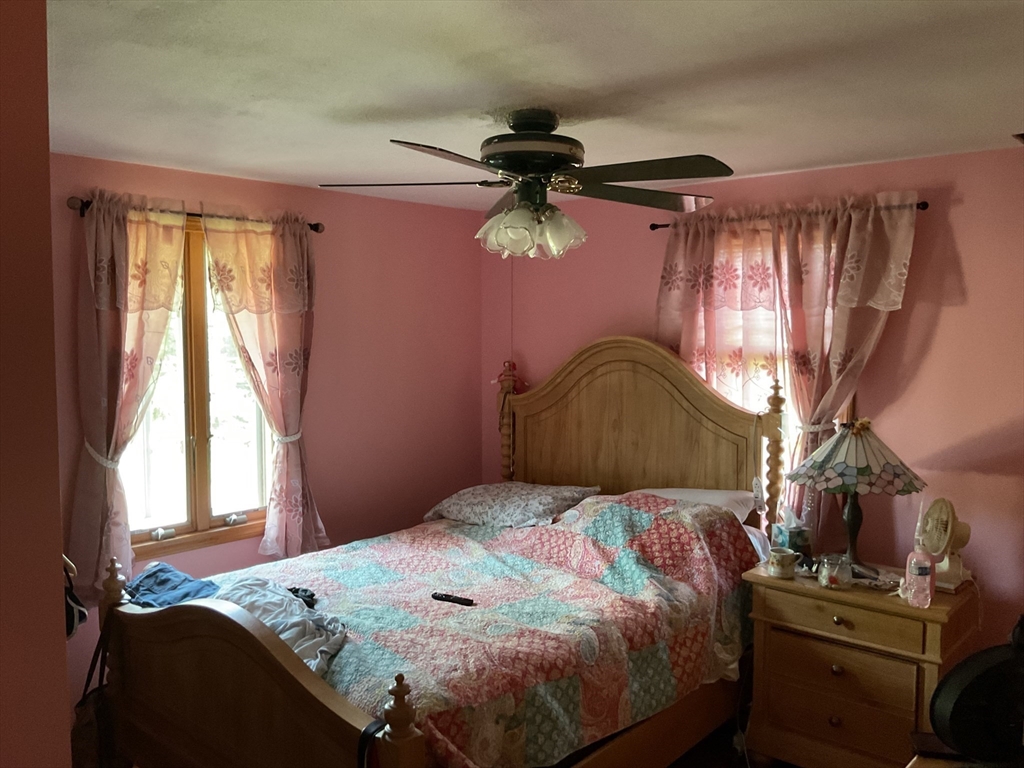 41 Hillside Drive Springfield, MA 01118 - Photo 9 of 25 a bedroom with a bed and a chandelier