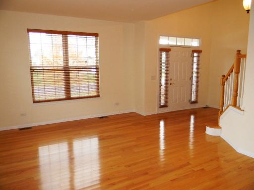 1782 Prairie Ridge Circle Lindenhurst, IL 60046 - Photo 2 of 15 a view of an empty room with window and wooden floor