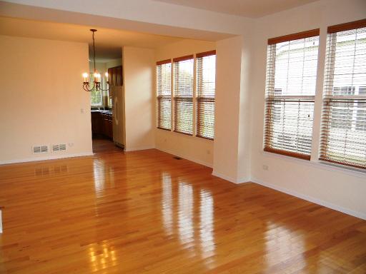 1782 Prairie Ridge Circle Lindenhurst, IL 60046 - Photo 3 of 15 a view of an empty room with window and wooden floor