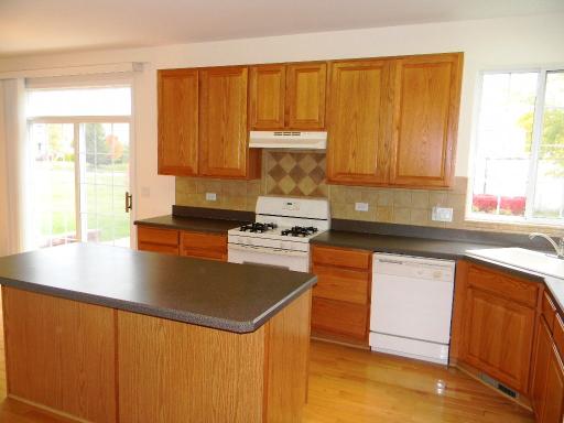 1782 Prairie Ridge Circle Lindenhurst, IL 60046 - Photo 4 of 15 a kitchen with stainless steel appliances granite countertop a sink stove and refrigerator