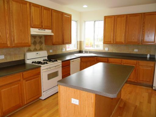 1782 Prairie Ridge Circle Lindenhurst, IL 60046 - Photo 5 of 15 a kitchen with granite countertop wooden cabinets stainless steel appliances and a sink