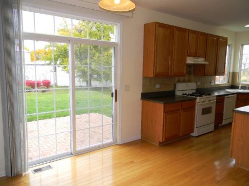 1782 Prairie Ridge Circle Lindenhurst, IL 60046 - Photo 7 of 15 a view of a kitchen with microwave and floor to ceiling window