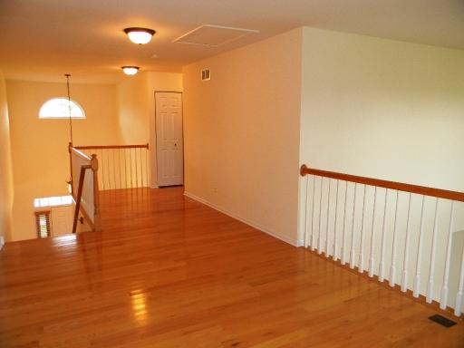 1782 Prairie Ridge Circle Lindenhurst, IL 60046 - Photo 8 of 15 a view of a room with wooden floor staircase and a glass door