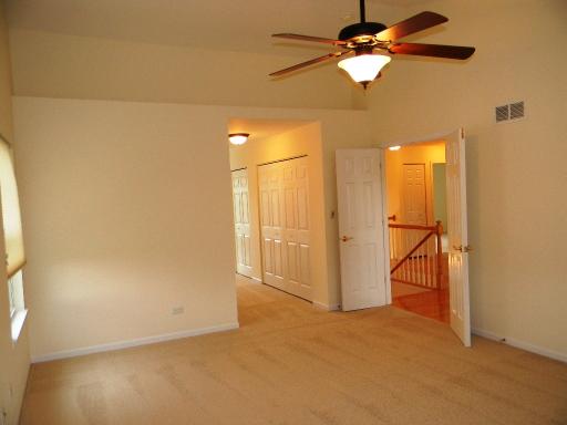 1782 Prairie Ridge Circle Lindenhurst, IL 60046 - Photo 9 of 15 an empty room with a ceiling fan and a window