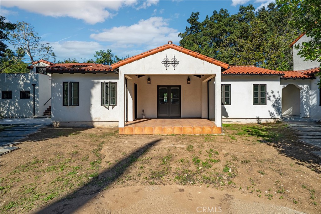 1591 Virginia Road San Marino, CA 91108 - Photo 16 of 74 a front view of a house with a yard and garage