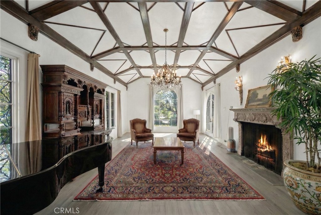 1591 Virginia Road San Marino, CA 91108 - Photo 30 of 74 a living room with a fireplace a rug potted plant and a large window