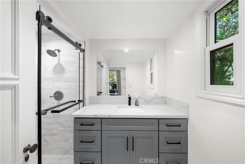 1591 Virginia Road San Marino, CA 91108 - Photo 36 of 74 a bathroom with a double vanity sink a mirror and a shower