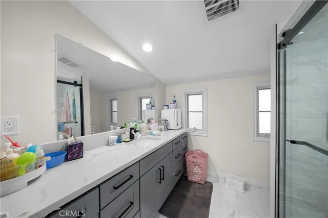 a spacious bedroom with a bed and window