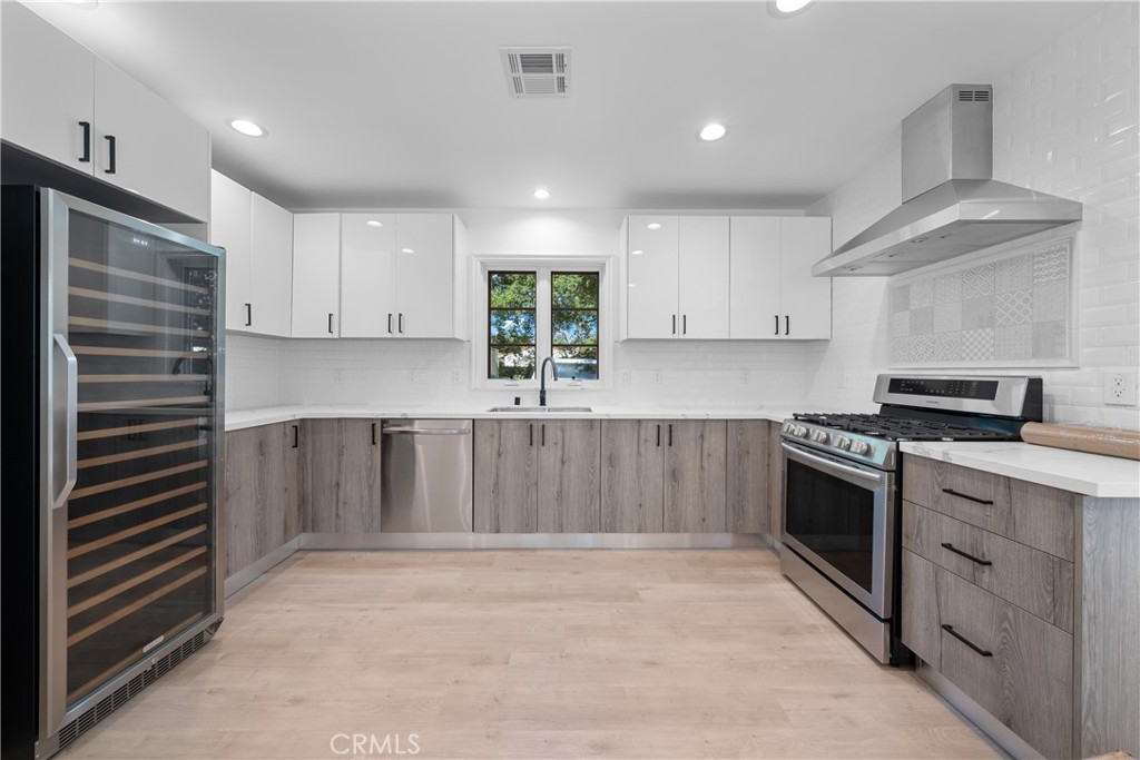 1591 Virginia Road San Marino, CA 91108 - Photo 57 of 74 a kitchen with kitchen island granite countertop a stove top oven a sink and dishwasher