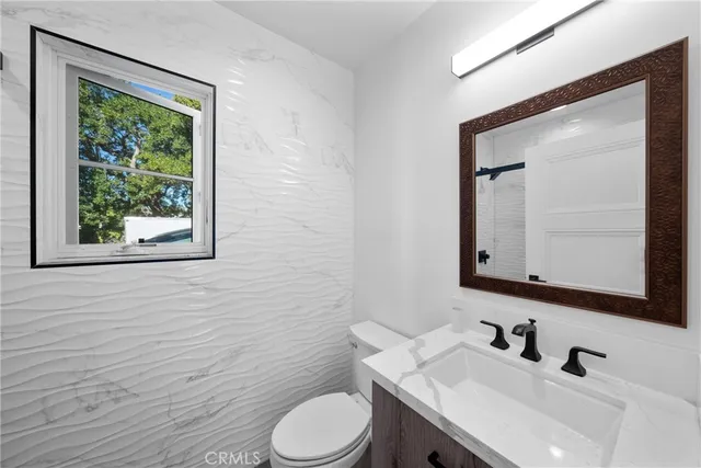 a kitchen with a sink a stove and cabinets
