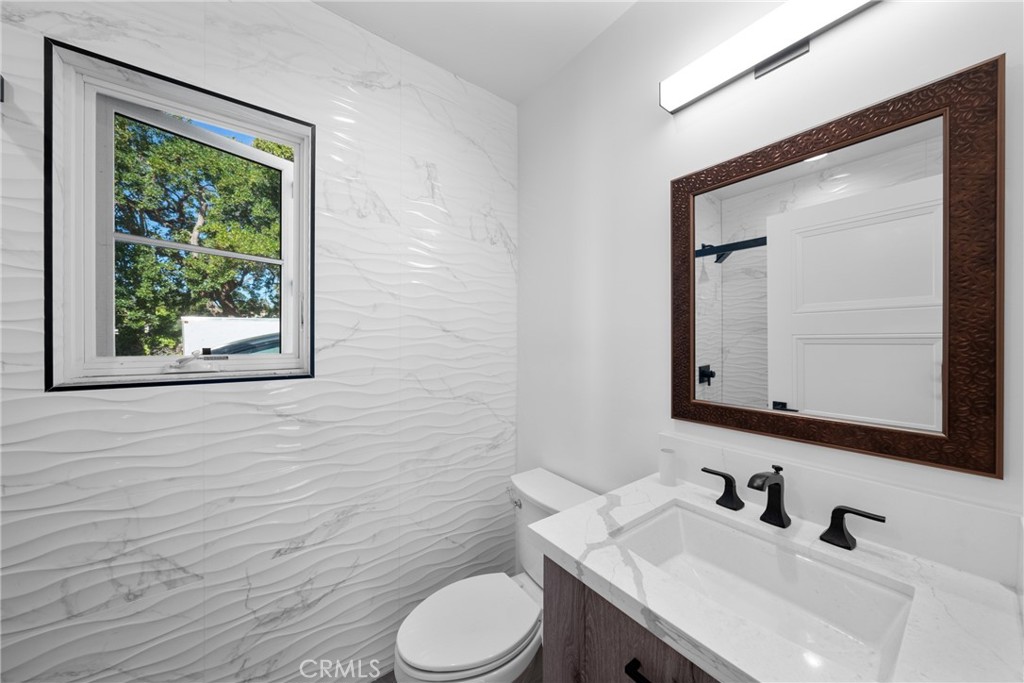1591 Virginia Road San Marino, CA 91108 - Photo 58 of 74 a bathroom with a toilet a sink and mirror