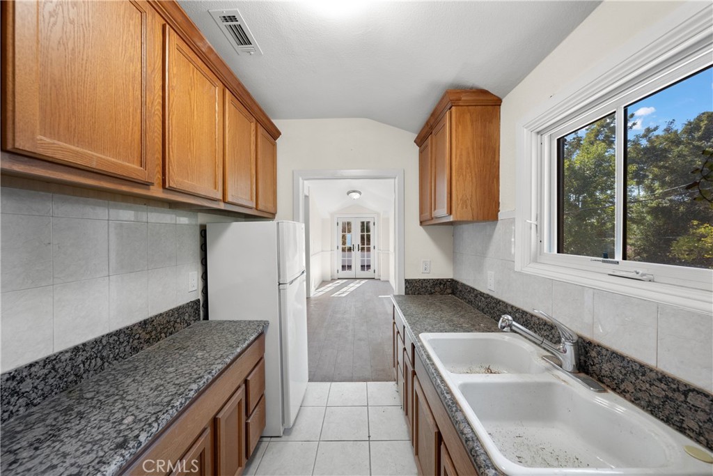 1591 Virginia Road San Marino, CA 91108 - Photo 67 of 74 a kitchen with a sink a stove and cabinets