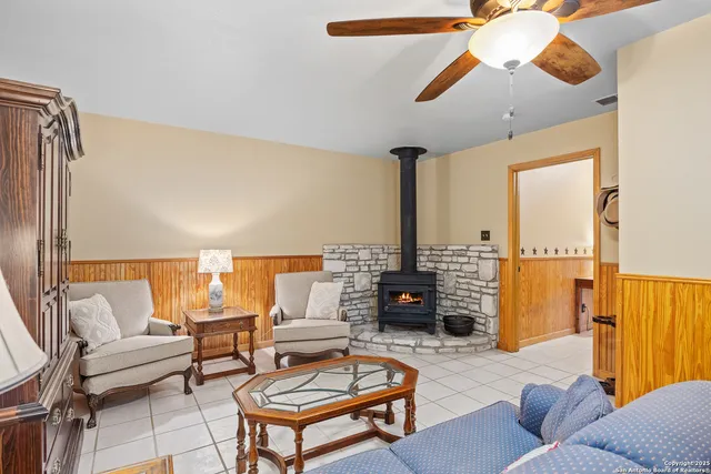 a living room with furniture a rug and a chandelier