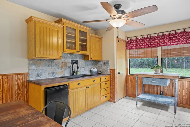 a kitchen with granite countertop a sink and dishwasher with a fireplace
