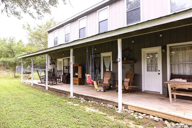 a view of a chair and tables in the patio