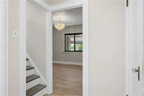 a view of a hallway with wooden floor and entryway