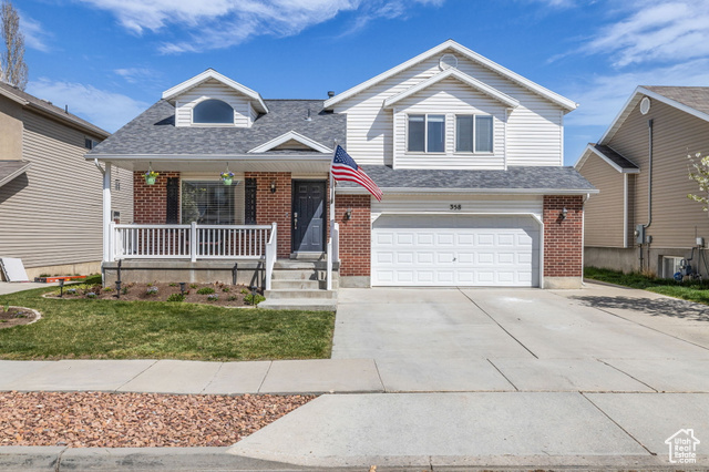 358 West Bricker Road Draper, UT 84020 - Photo 1 of 1 View of front of house featuring a porch, roof with shingles, a garage, and brick siding