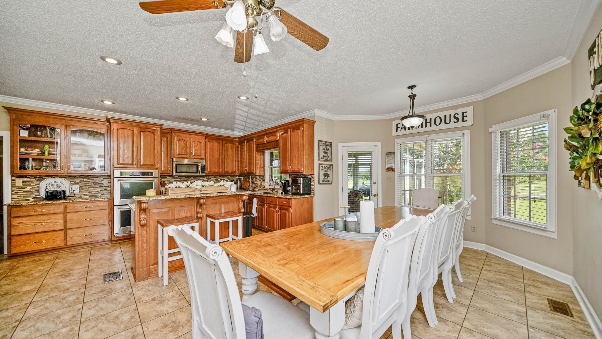 21 Partin Road Taft, TN 38488 - Photo 10 of 30 a room with stainless steel appliances kitchen island granite countertop a refrigerator a stove top oven a dining table and chairs with wooden floor