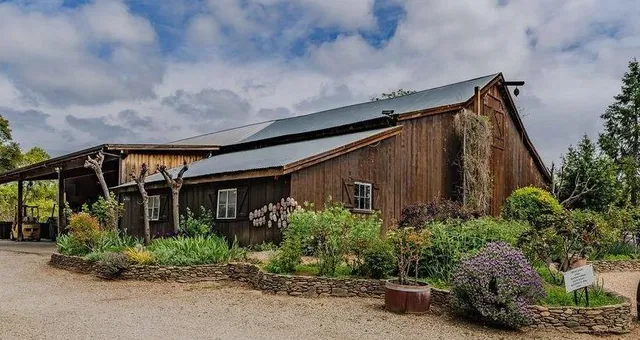 an aerial view of a house with garden space and street view