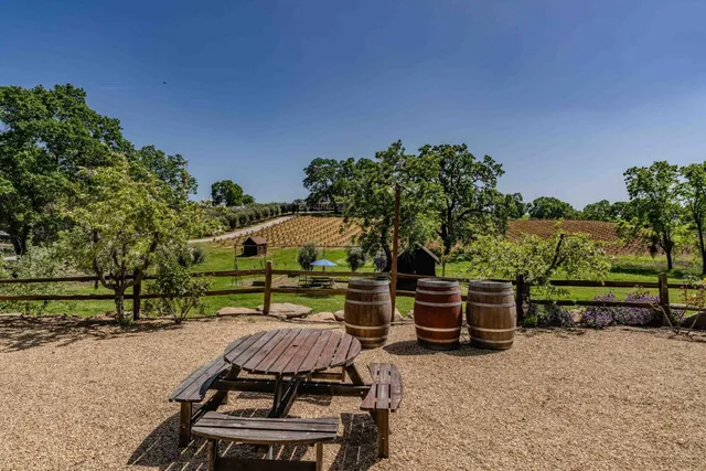 a front view of a house with swimming pool and sitting area