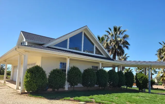 a view of a dining room with furniture a chandelier and wooden floor