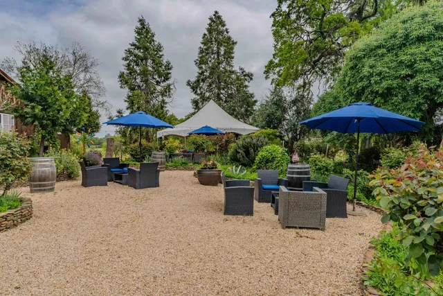 an aerial view of a house with garden space and street view