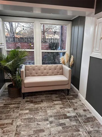 a living room filled with furniture and a chandelier
