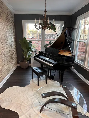 a white toilet sitting next to a white sink and vanity