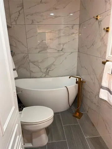 a living room with a bed furniture and a window