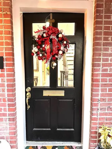 a view of a brick house with potted plants