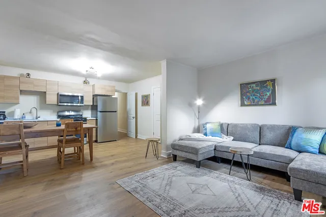 a living room with furniture and kitchen view