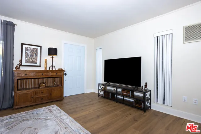 a living room with furniture and flat screen tv