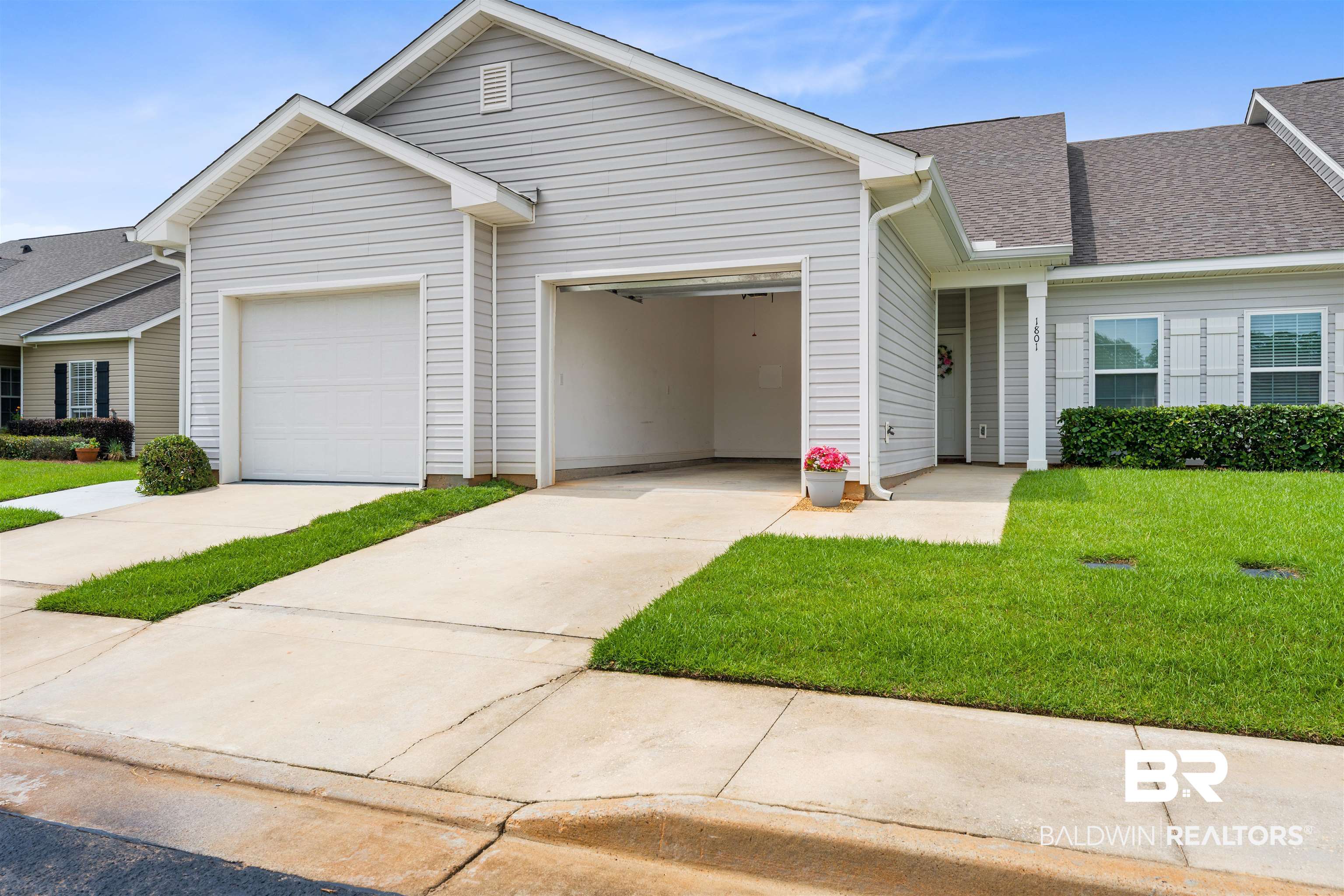 2651 South Juniper Street, Unit 1801 Foley, AL 36535 - Photo 2 of 16 Two-car garage with one open bay and one closed overhead door, featuring concrete driveways and a gray shingled roof