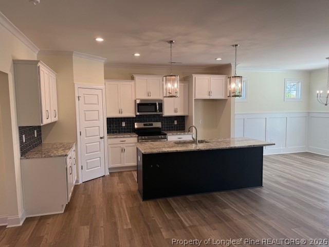 180 Rabbit Run Drive Smithfield, NC 27577 - Photo 4 of 19 a large kitchen with stainless steel appliances kitchen island granite countertop a stove a refrigerator a sink and dishwasher with wooden floor