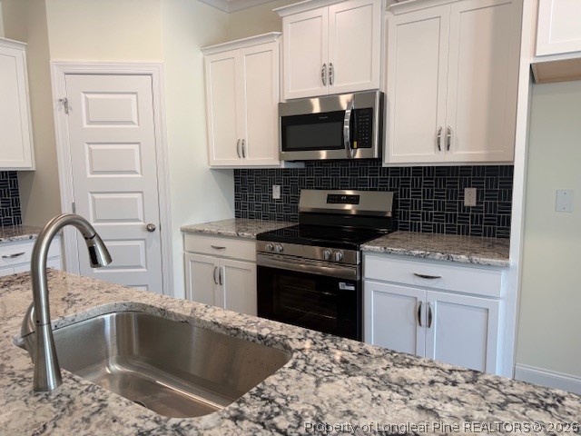 180 Rabbit Run Drive Smithfield, NC 27577 - Photo 6 of 19 a kitchen with a sink stove and microwave