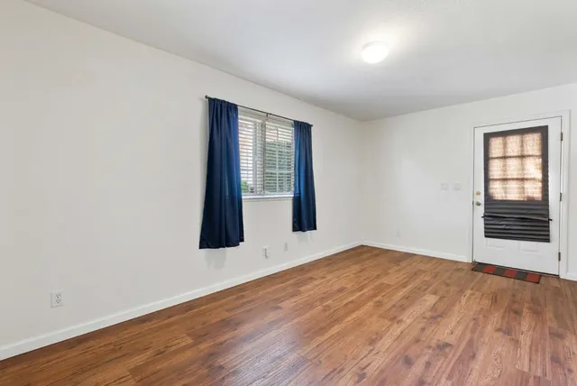 a living room with furniture and large windows