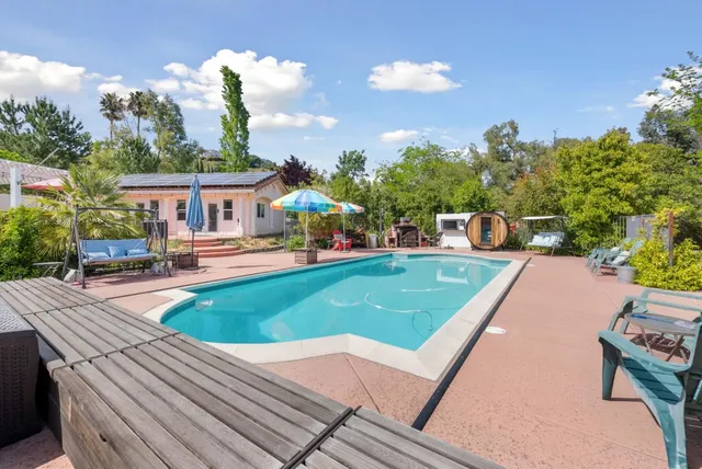 a view of a brick house with a large windows and a large tree