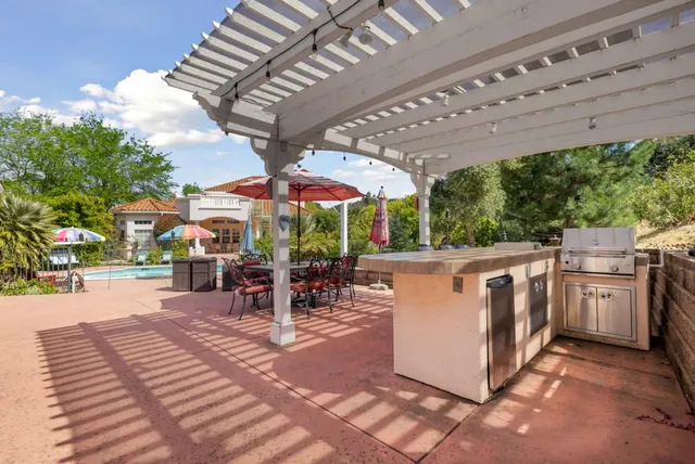 a view of a dining room with furniture a chandelier and wooden floor