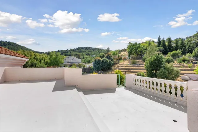 a dining room with furniture a chandelier and wooden floor
