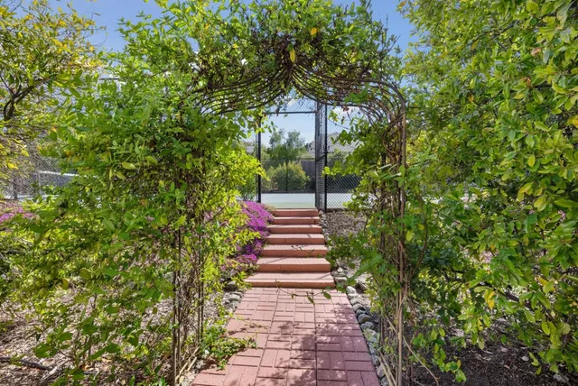 a spacious bedroom with a large bed and a chandelier