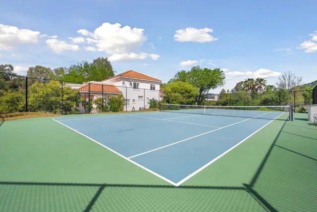 a bathroom with a tub sink shower and mirror