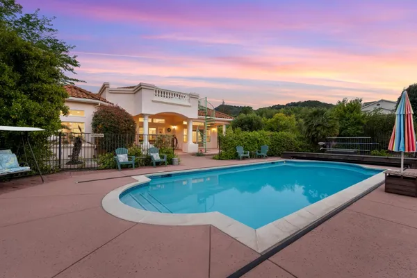 an aerial view of a house with garden space and street view