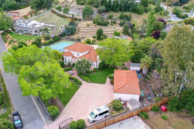 an aerial view of a house with a yard