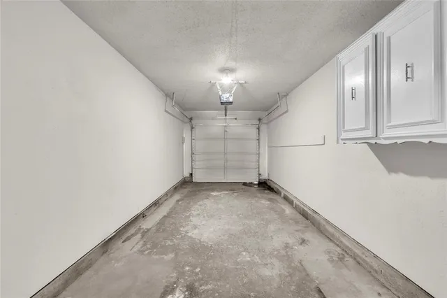 a kitchen with a sink white cabinets and stainless steel appliances