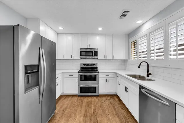 a view of a hallway with wooden floor windows and livingroom