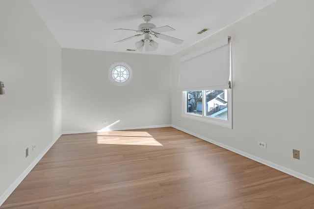 wooden floor in an empty room with a window