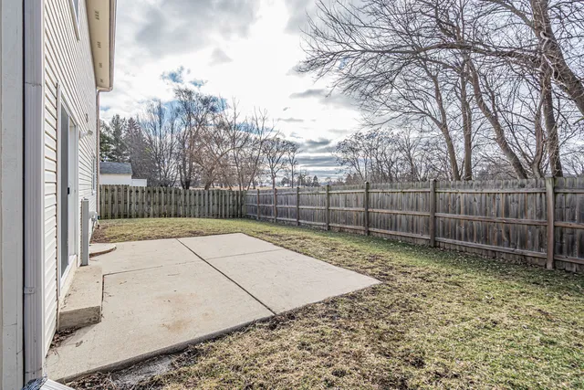 a view of a backyard with wooden fence
